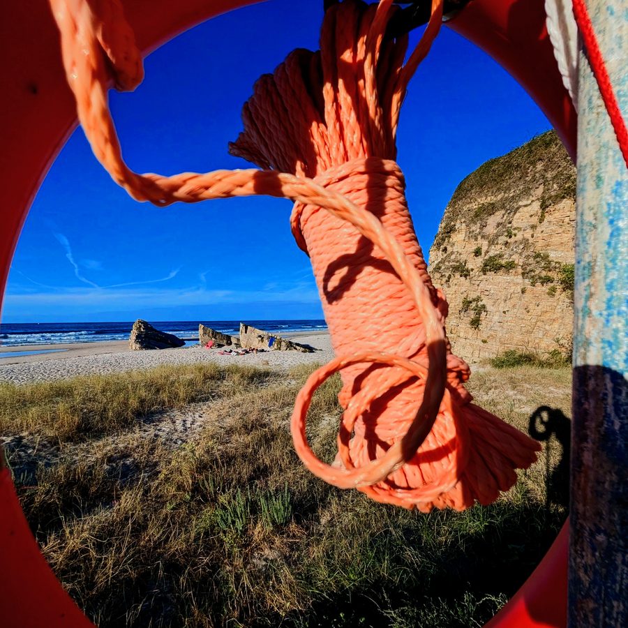 Beach framed through a life ring, shot by Ian Thistleton