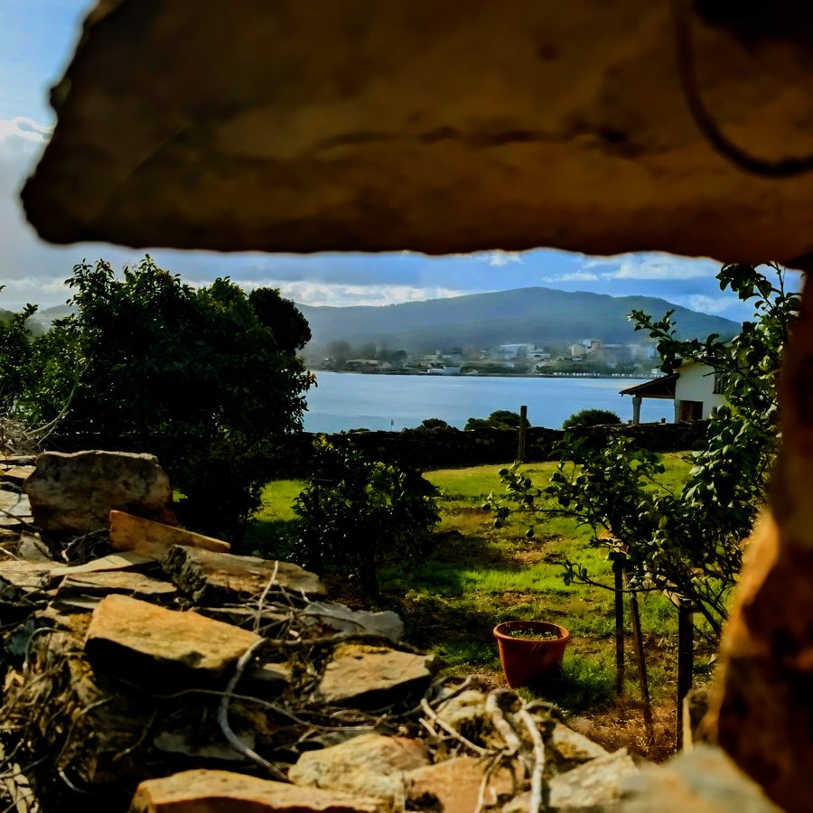 Coastal view framed through a stone window, shot by Ian Thistleton
